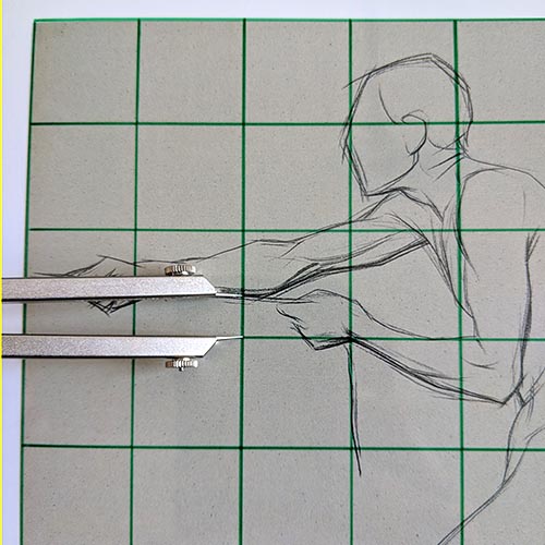 Calipers on top of a drawing with a grid.