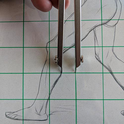 Calipers measuring a drawing.