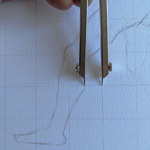 Calipers measuring a drawing.