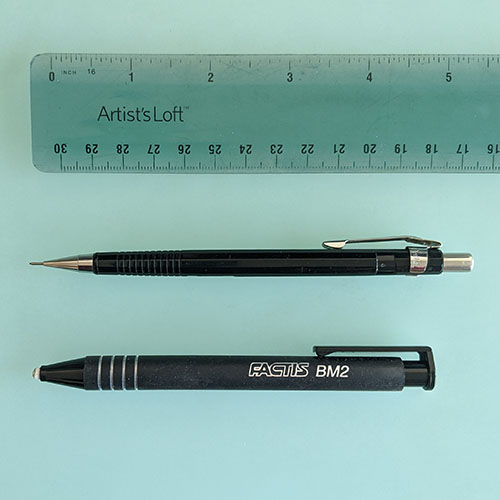 A photo of a ruler, mechanical pencil, and eraser. 